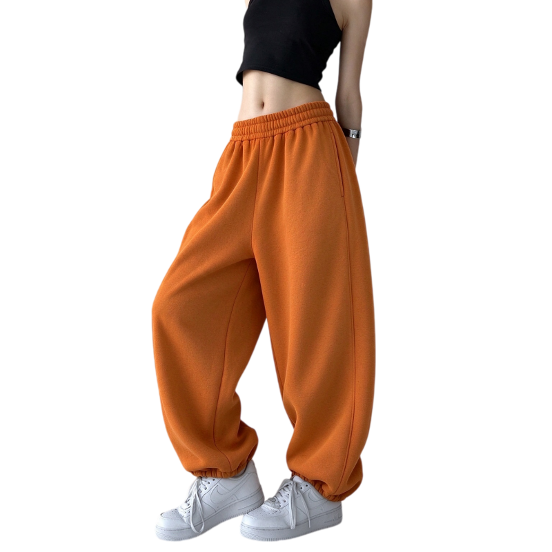 Women's thermal baggy jogger sweatpants in autumn orange showing relaxed fit and high waist