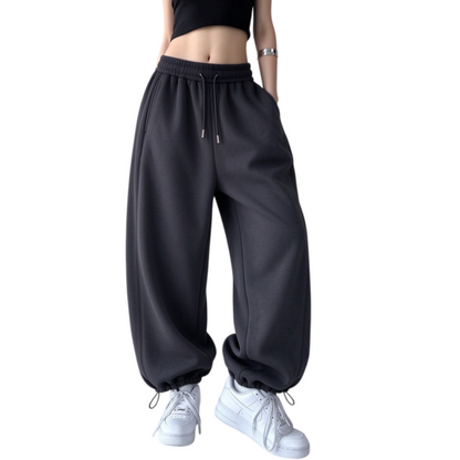 Women's fleece-lined wide leg sweatpants in deep gray featuring drawstring high waistband and cinched ankle cuffs