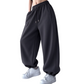Side three-quarter view of women's deep gray fleece jogger pants with elastic high waist and side pockets
