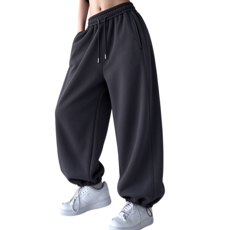 Side three-quarter view of women's deep gray fleece jogger pants with elastic high waist and side pockets
